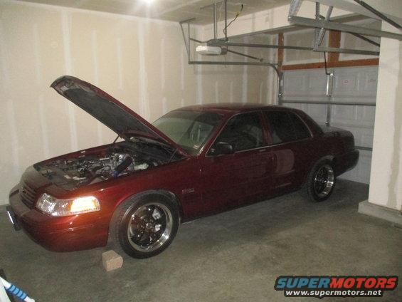 Maroon 2004 Ford Crown Victoria with hood open, parked in garage