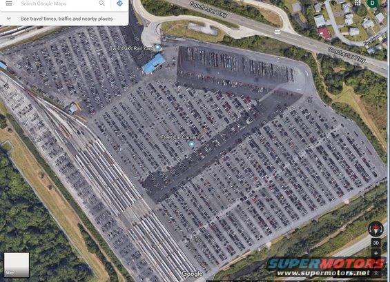 Aerial view of Twin Oaks Rail Yard car lot with many vehicles parked