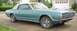 1968 Mercury Cougar - A teal 1968 Mercury Cougar convertible with a white top is parked in a driveway.