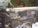 1991 Ford Crown Victoria - Close-up of brake master cylinder and fuse box components in an engine compartment.