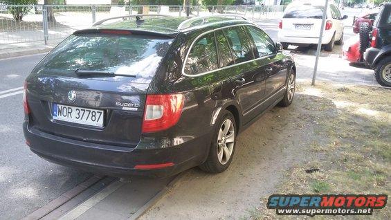 Dark station wagon with license plate WOR 37787 parked on a street next to other vehicles