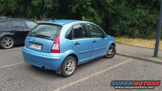 Blue Citroen C3 parked next to a black SUV. License plate is WP1 67071