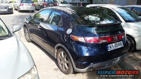 Dark blue 2006 Honda Civic hatchback rear view, parked next to other cars. License plate WY-8044K