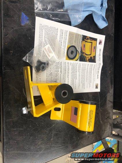 Yellow engine mount part with instructions and hardware
