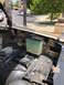 1981 Ford Bronco - The engine bay of a 1981 Ford Bronco is visible, with a coolant reservoir and hood hinge in view.