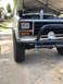1981 Ford Bronco - Front view of a white 1981 Ford Bronco, an aftermarket bumper and off-road tires.