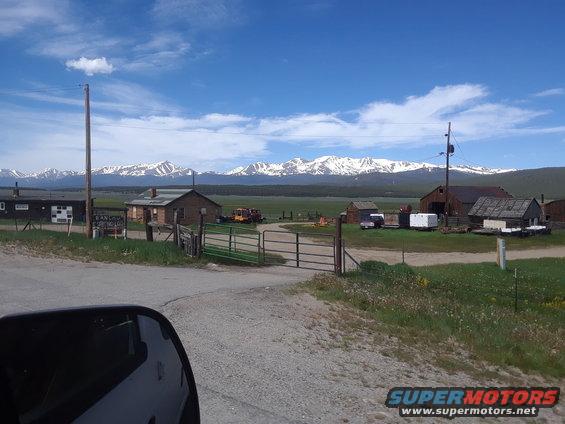 Farm scene with snow-capped mountains in the background