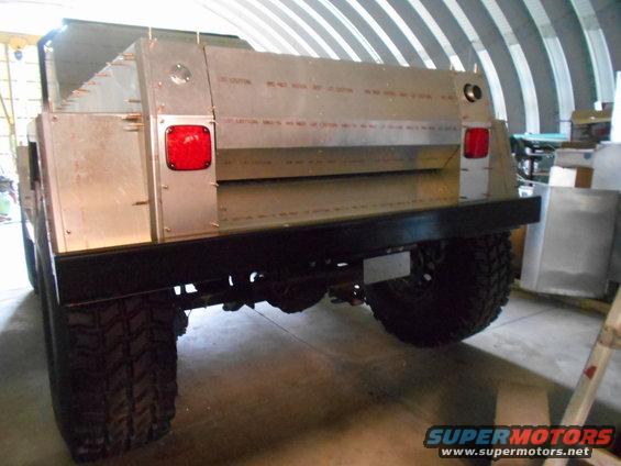 Rear view of a custom truck with a silver aluminum bed and red taillights