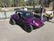 1970 Volkswagen Beetle - Two custom dune buggies are parked side-by-side on pavement with people standing nearby.