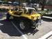 1970 Volkswagen Beetle - Yellow dune buggy at an event, likely a custom build based on a classic VW Beetle chassis.