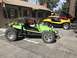 1970 Volkswagen Beetle - Three dune buggies are parked in front of a log cabin, with the closest one being lime green.