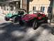 1970 Volkswagen Beetle - Two custom dune buggies are parked side-by-side in front of a building.