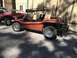 1970 Volkswagen Beetle - A custom orange dune buggy with a roof rack is parked outdoors next to another dune buggy.
