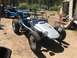 1970 Volkswagen Beetle - Custom dune buggy with exposed engine and roll cage parked outdoors.