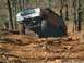 1979 Ford Bronco - This modified 1979 Ford Bronco navigates a challenging off-road course, demonstrating its suspension and traction capabilities.