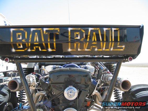 Rear engine view of custom "BAT RAIL" vehicle with gold lettering