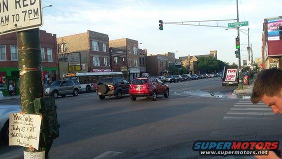 Street intersection with cars and traffic signals in urban neighborhood