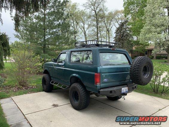 1996 Ford Bronco, green, with roof rack and spare tire mounted on the rear bumper