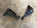1994 Ford Bronco - Two damaged automotive components lie on a textured concrete surface.