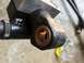 1994 Ford Bronco - A close-up view of a black tailgate hinge component a brass bushing.