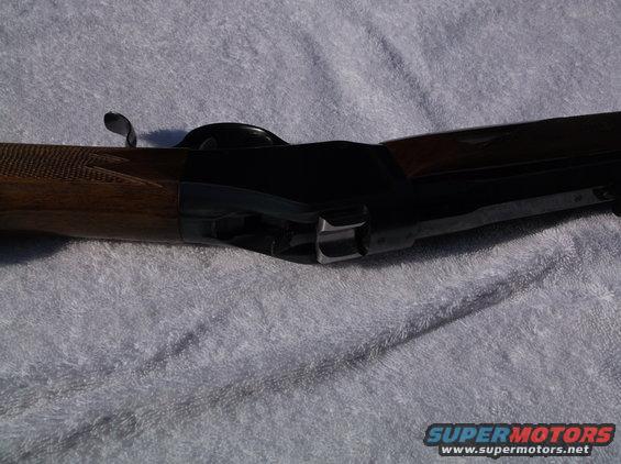 Browning shotgun receiver with wood stock and metal action, viewed from the side