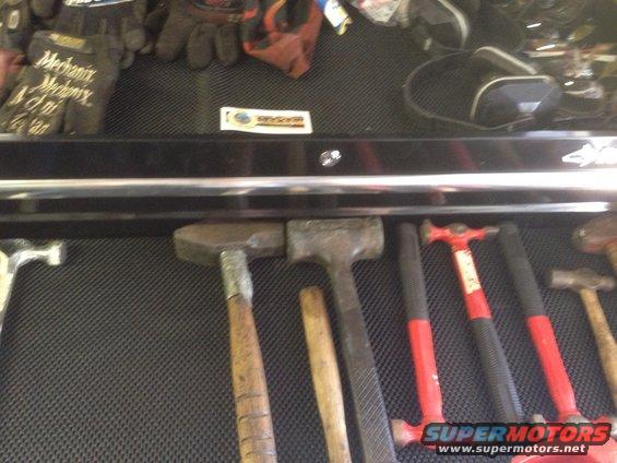 Tool drawer with various hammers and gloves. Includes a "SuperMotors" logo