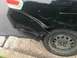2008 Ford Focus - The rear quarter panel of a black 2008 Ford Focus shows extensive damage from an apparent collision.