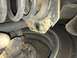 2008 Ford Focus - Undercarriage view of a vehicle's suspension system and tire, showing signs of wear and rust.