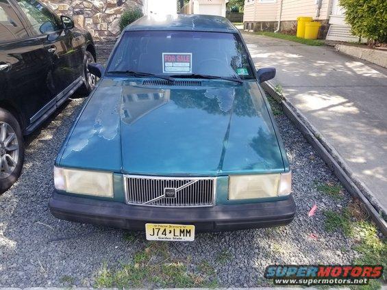 Teal 1994 Volvo 940 wagon front view with 'FOR SALE' sign in window