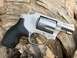 1993 Ford Bronco - A silver revolver with a black grip is displayed on a piece of wood, with "Airweight" visible on its frame.