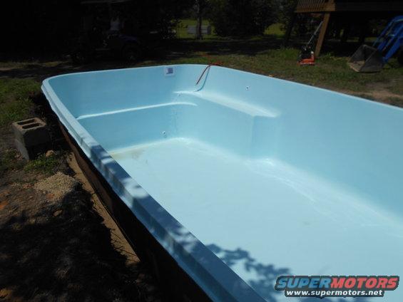 Light blue swimming pool interior with steps