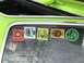1974 Dodge Challenger - Several Mopar-themed stickers adorn the window of a green vehicle.
