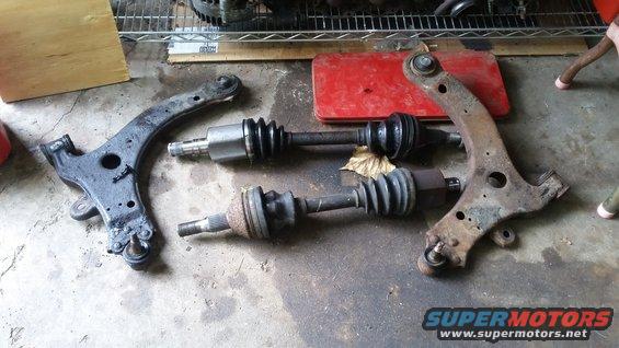 Control arms and CV axles on concrete floor