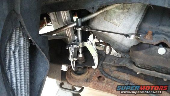 Gear puller tool attached to a vehicle's suspension component