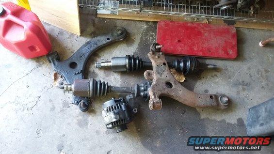 Automotive parts: control arms, CV axles, alternator, and red gas can