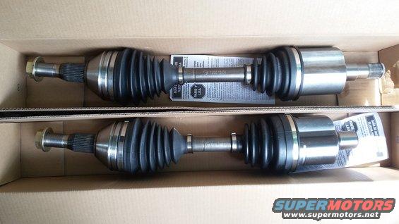 Two new CV axles in a cardboard box, with instructions