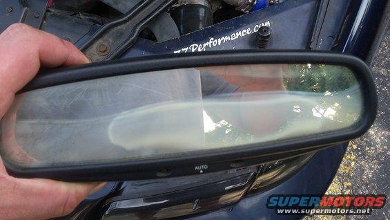 Rear-view mirror with 'AUTO' button and "-7performance.com" sticker on car hood