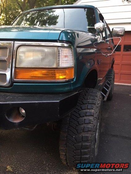 Green 1996 Ford Bronco front quarter view with aftermarket bumper and large tires