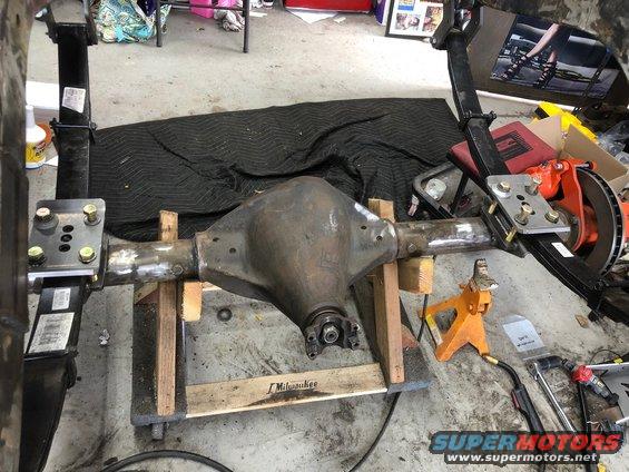 Rear axle assembly on wooden blocks with suspension components