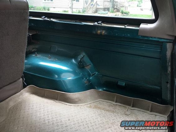 Teal interior cargo area of a 1996 Ford Bronco with rubber floor mat