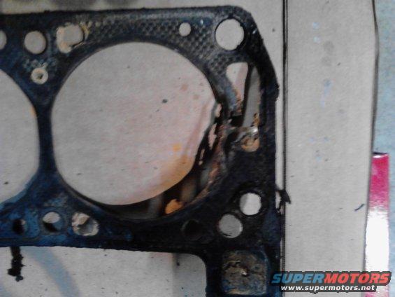 Damaged engine gasket with rust and debris