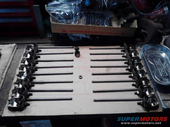 engine valve train components laid out on cardboard