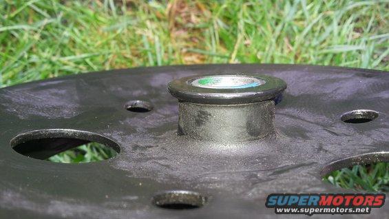 Wheel hub part with green and blue cap, Supermotors logo visible