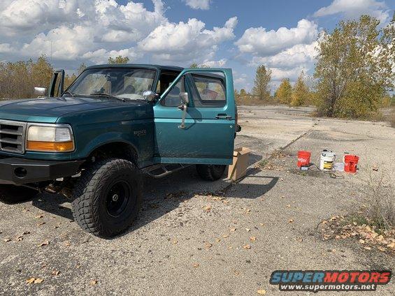 1996 Ford Bronco parked outdoors with driver's door and passenger door open