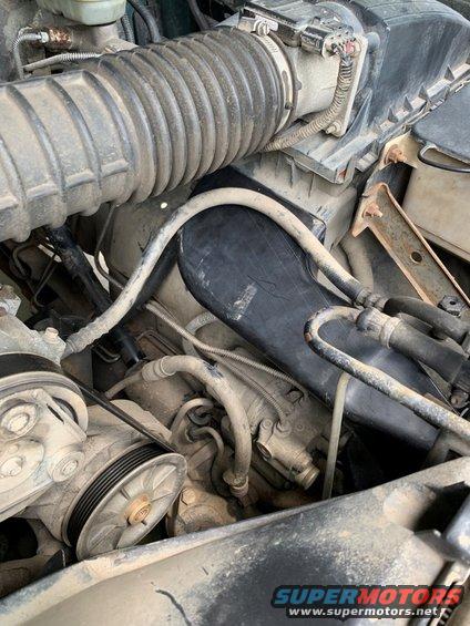 Engine bay of a 1996 Ford Bronco showing air intake hose and pulleys