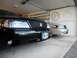 2003 Mercury Marauder - Two Mercury Marauders are parked side-by-side in a garage, with the black car in the foreground.