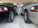 2003 Mercury Marauder - Two 2003 Mercury Marauders are parked next to each other in a garage with license plates on the wall.