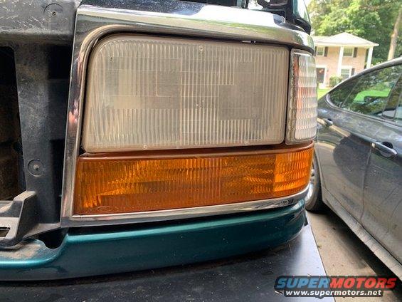 Close-up of a 1992 Ford F-Series truck headlight and amber turn signal