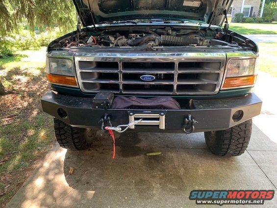 1996 Ford Bronco front end with hood open, showing engine and aftermarket winch bumper