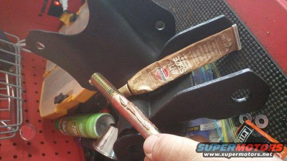 Tube of Permatex Anti-Seize Lubricant next to a bolt and suspension part
